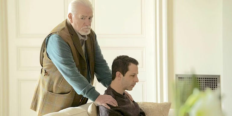 Logan with his hands on Kendall's shoulders in Succession