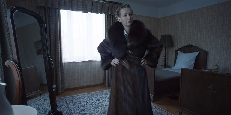 Sandra Hüller as Hedwig Höss posing in a fur coat in The Zone of Interest