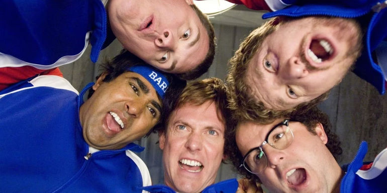 The Broken Lizard crew standing in a circle with their head together cheering in Beerfest.