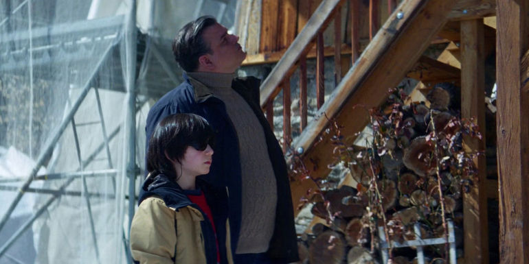 Daniel (Milo Machado Graner) and the investigator walking outside in Anatomy of a Fall.