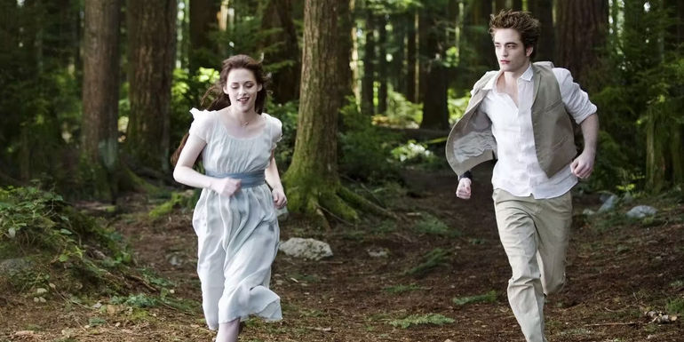 Bella and Edward running in the woods in the Twilight movie