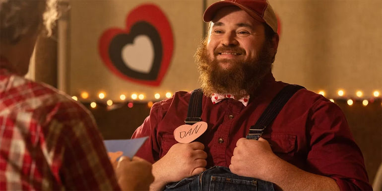 Squirrely Dan (K. Trevor Wilson) smiling while holding his dungarees in Letterkenny Valentine's Day