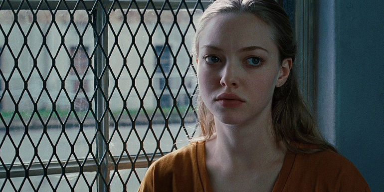 Amanda Seyfried's Needy stands by a barred window in Jennifer's Body's ending