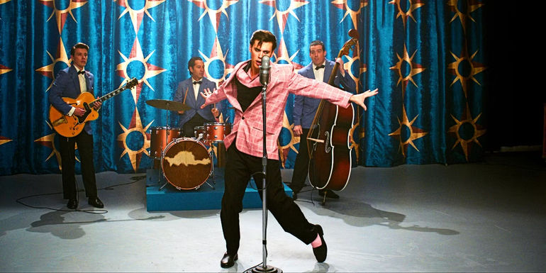 Austin Butler dancing in a pink jacket in Elvis