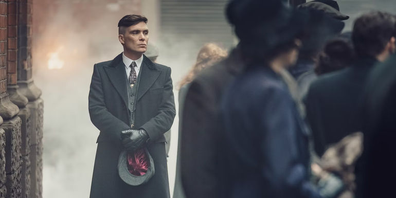 Peaky Blinders - Photo of Tommy shelby standing behind a crowd in the street