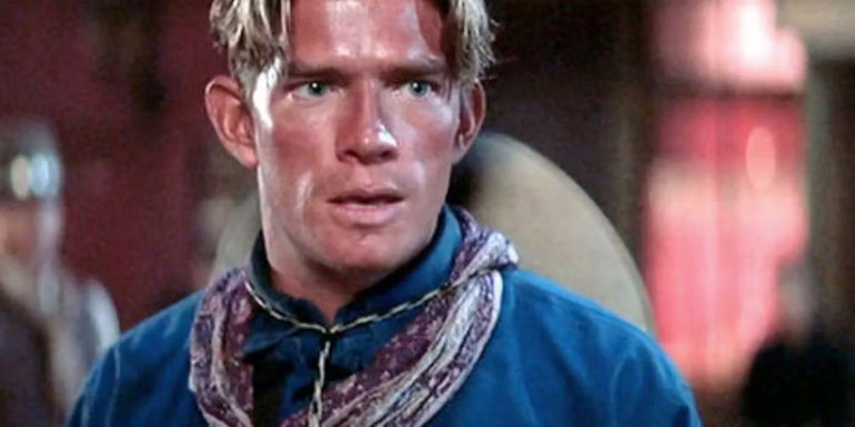 A sweaty Billy Clanton looks at Doc Holliday in Tombstone.