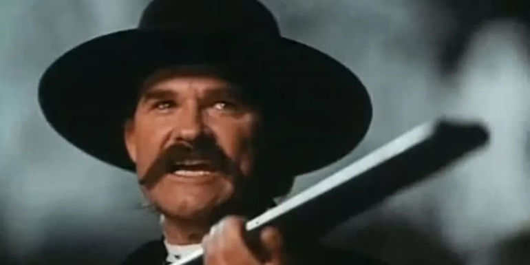 An angry Wyatt Earp in raising his shotgun Tombstone