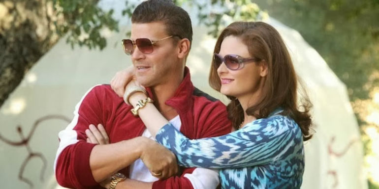 Brennan with her arms around Booth while undercover in Bones