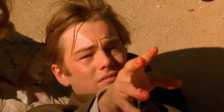 A distressed Leonardo DiCaprio reaching out his bloody fingers in The Quick and the Dead.