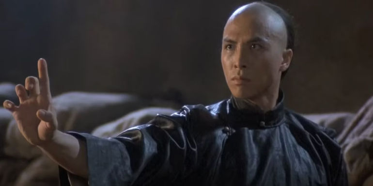 Donnie Yen holding a hand out with one finger up in Iron Monkey