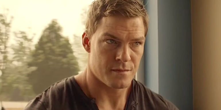 Alan Ritchson as Jack Reacher looks skeptical in Reacher