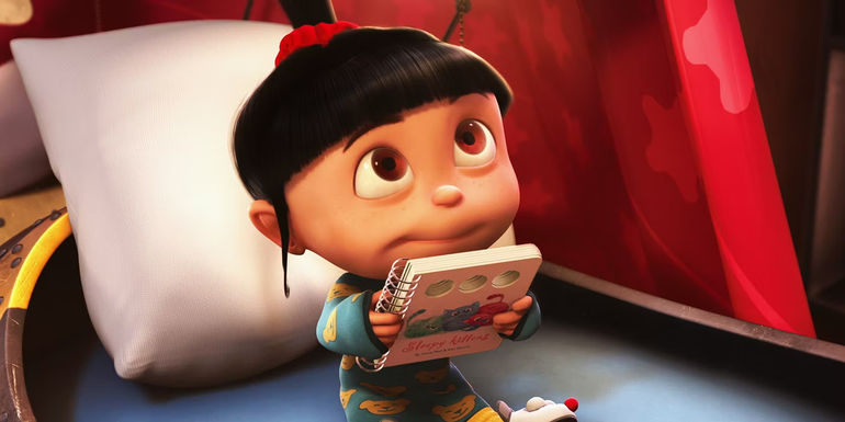 Despicable Me Agnes in bed holding a book