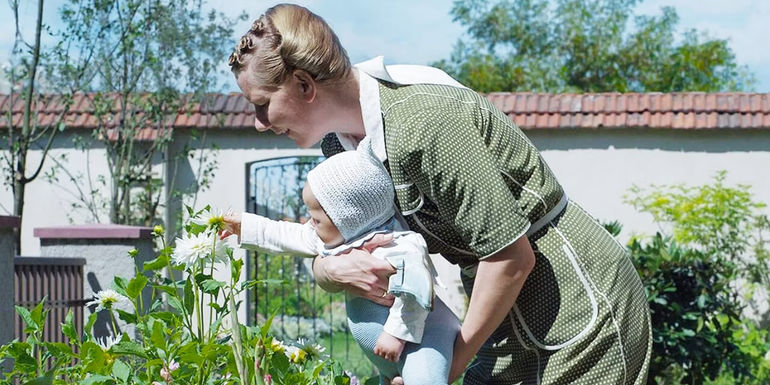 Sandra Hüller holding a baby in The Zone of Interest