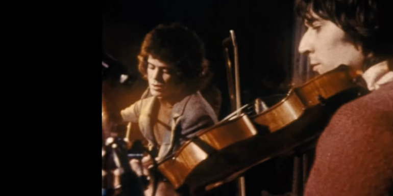 A semi split-screen of The Velvet Underground performing on stage as seen in The Velvet Underground documentary trailer