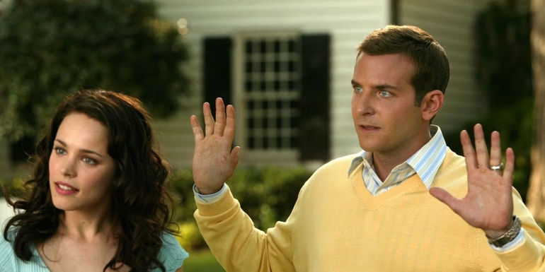 Bradley Cooper as Sack Lodge holding up his hands next to Rachel McAdams in Wedding Crashers