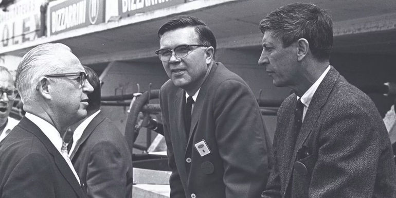 Enzo Ferrari, Don Frey, and Leo Beebe stalking together at a race.