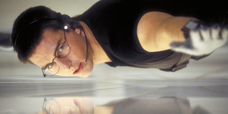 Ethan Hunt (Tom Cruise) scaling into a vault in Mission: Impossible (1996)