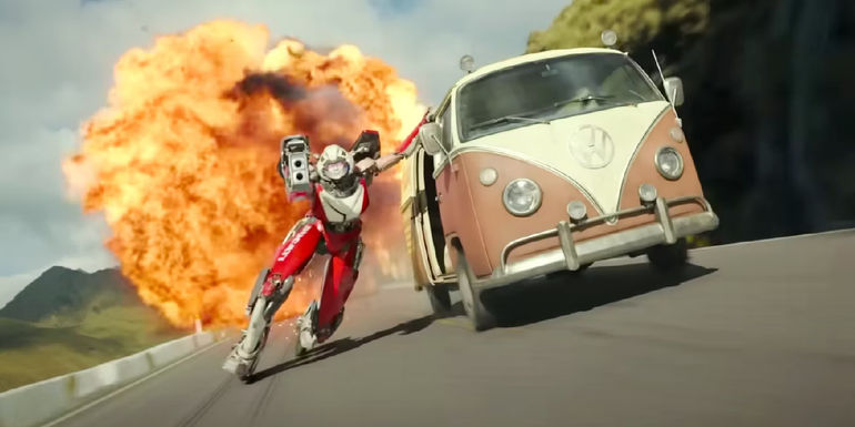Arcee aiming a gun and holding onto a car in Transformers Rise of the Beasts.