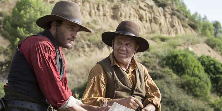 John C Reilly and Joaquin Phoenix riding horses in The Sisters Brothers
