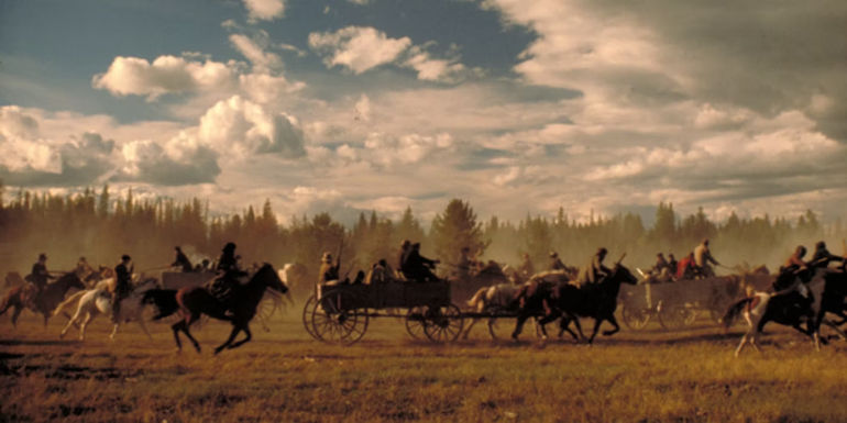 Horses pulling wagons in a field in Heaven's Gate 1980