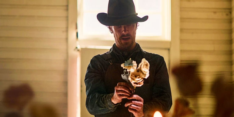 Benedict Cumberbatch holding paper flowers in The Power of the Dog