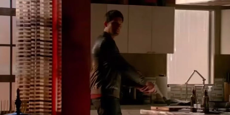 Caleb Brown (Kristoffer Polaha) pointing a gun and looking over at someone in Castle.