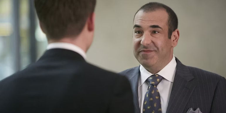 Louis Litt smiling at Mike Ross in Suits