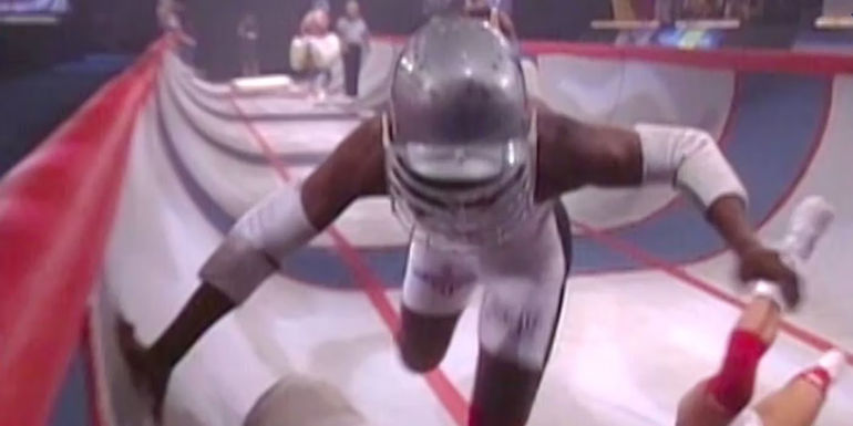 A man running through The Gauntlet in American Gladiators.