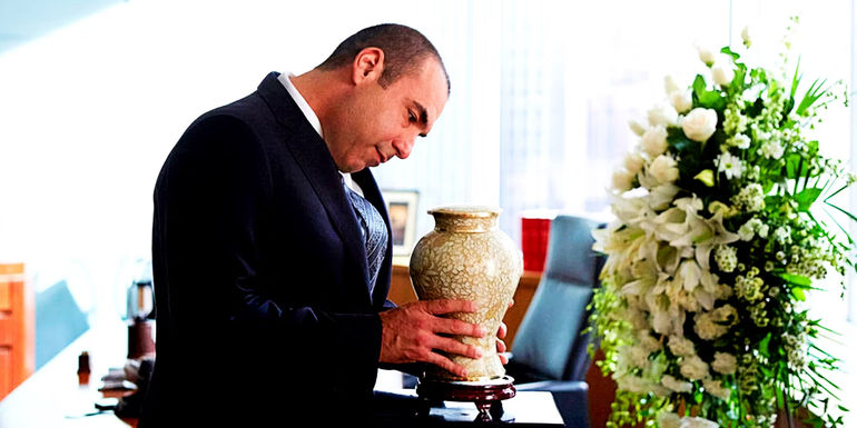 Louis holding Norma's urn in Suits