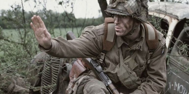 Lt Winters in Band of Brothers Carentan Episode holding hand up to soldiers to wait