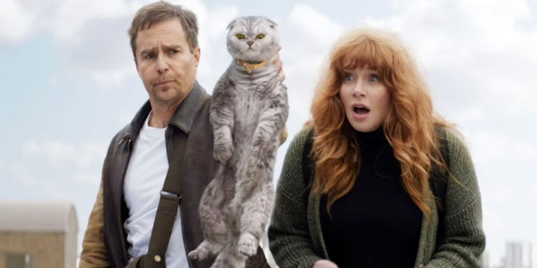 Sam Rockwell as Aiden holds a cat and Bryce Dallas Howard as Elly looks surprised as their characters in Argylle.