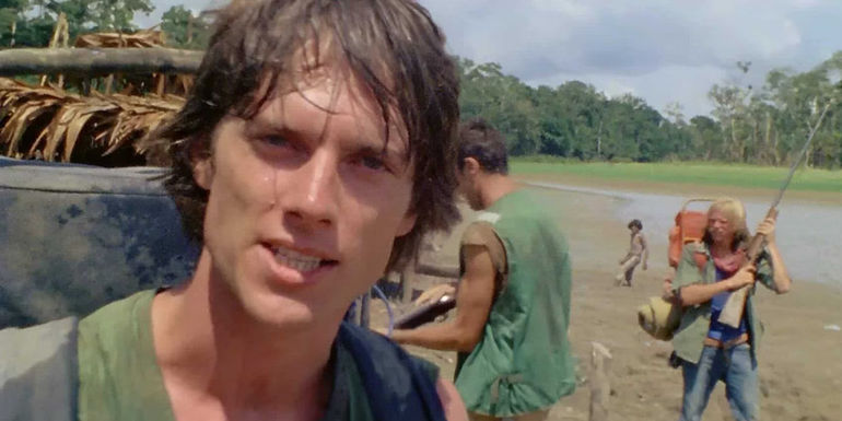 A filmmaker looks at the camera in a still from the 1980 horror movie Cannibal Holocaust.