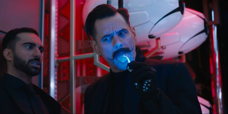 Dr. Robotnik (Jim Carrey) licking something with Agent Stone looking concerned in Sonic the Hedgehog 2