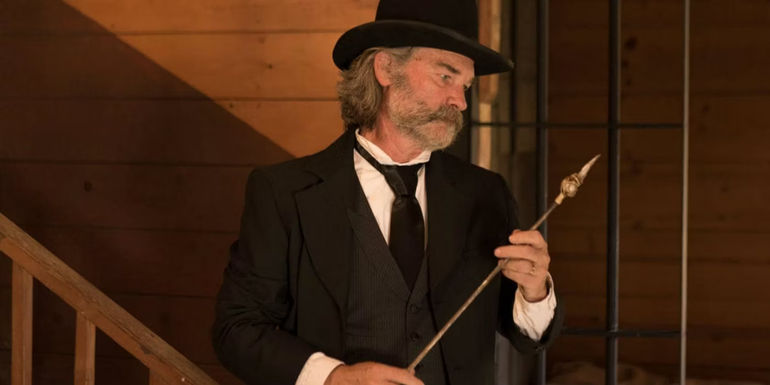 Kurt Russell as Sheriff Franklin inspecting a fire poker in Bone Tomahawk