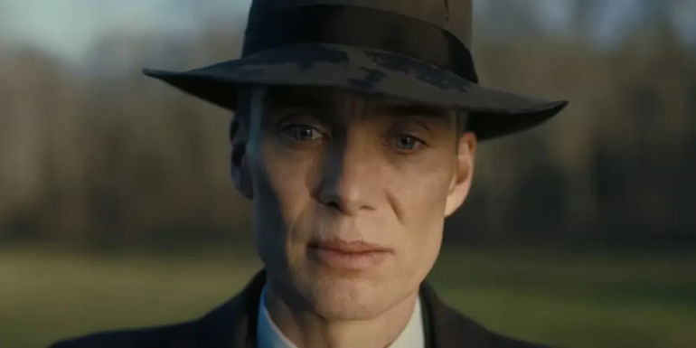 Oppenheimer is wearing his hat and looking down in Oppenheimer.