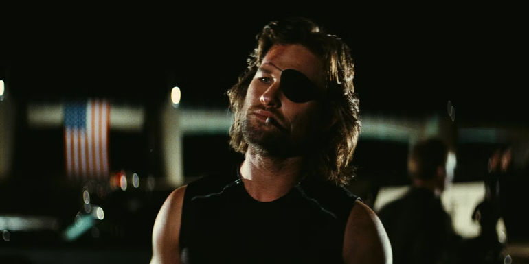 Kurt Russell as Snake Plisken in Escape From New York looking at something 