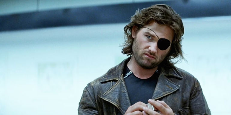 Kurt Russell as Snake Plissken playing with a lighter in Escape from New York.