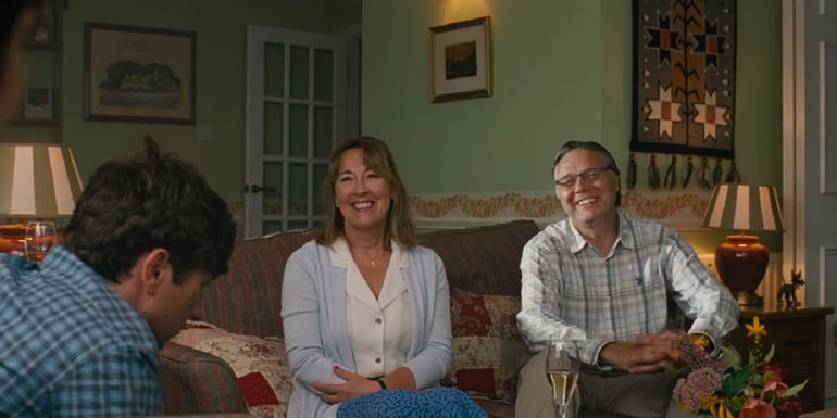 Oliver talking to his parents in their living room in Saltburn