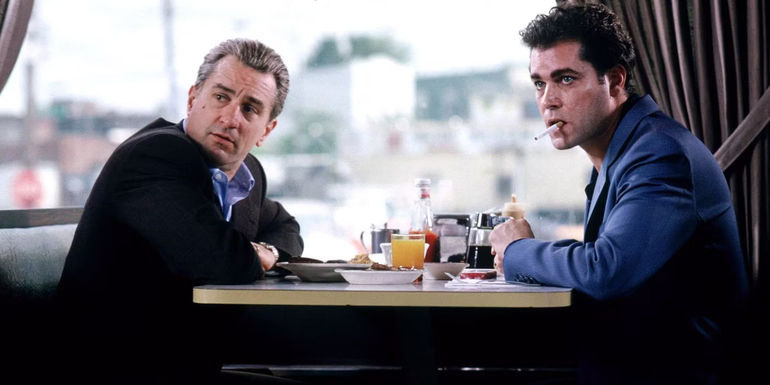 Robert DeNiro and Ray Liotta sitting at a diner table n Goodfellas 