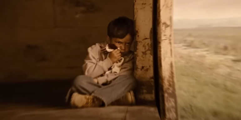 3-5Pierce Gagnon as Cid with a bloody rag to his face on a train in Looper