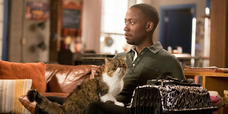Ferguson on Winston's lap in New Girl