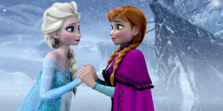 Anna and Elsa holding hands and looking at each other in Frozen