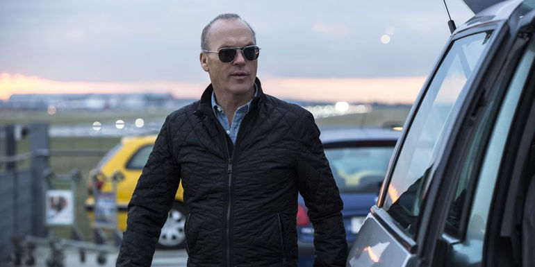 Michael Keaton as Stan Hurley stepping out of a car in American Assassin