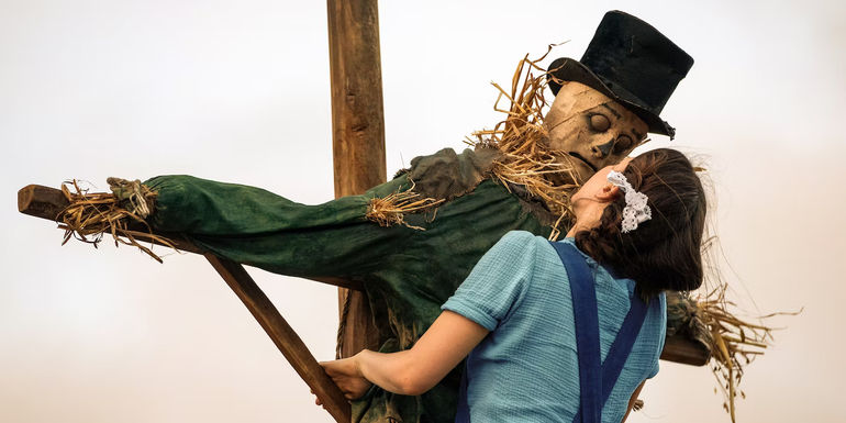 Pearl climbing up a scarecrow.