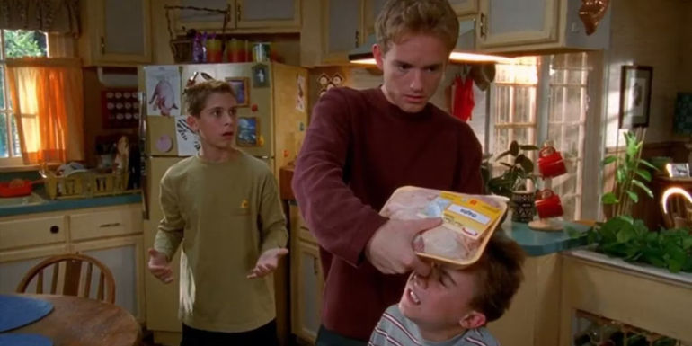 Reese watching Francis put frozen chicken on Malcolm's head