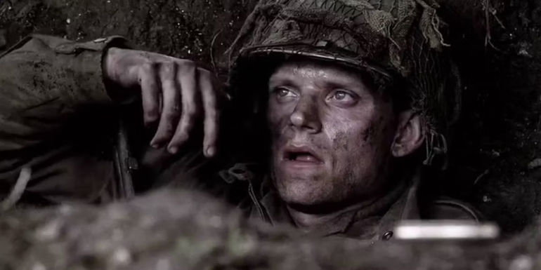 Blithe sitting in a trench in Band of Brothers