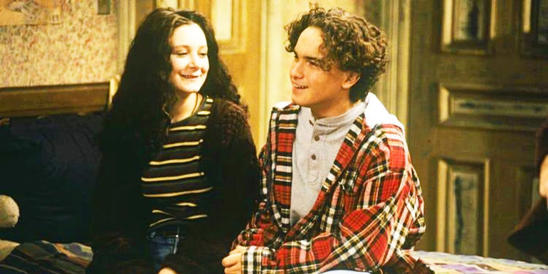 Darlene and David in sitting in a bed in Roseanne