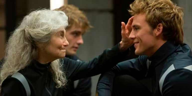 Finnick and Mags smiling at each other in The Hunger Games Catching Fire