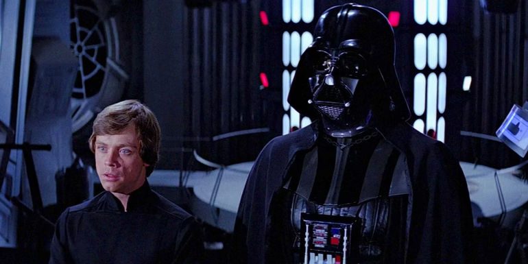 Luke and Darth Vader stand next to one another in the Emperor's throne room in Return of the Jedi.