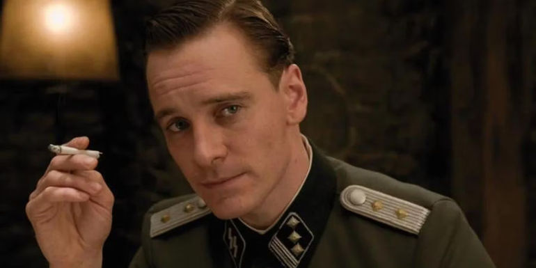 Michael Fassbender as Archie Hicox holds a cigarette in Inglourious Basterds.